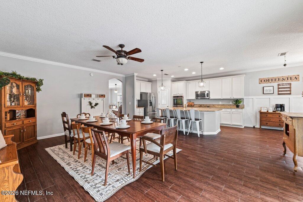 81015 Lockhaven Drive Yulee, FL 32097 - Photo 22 of 55 a view of a dining room with furniture and wooden floor