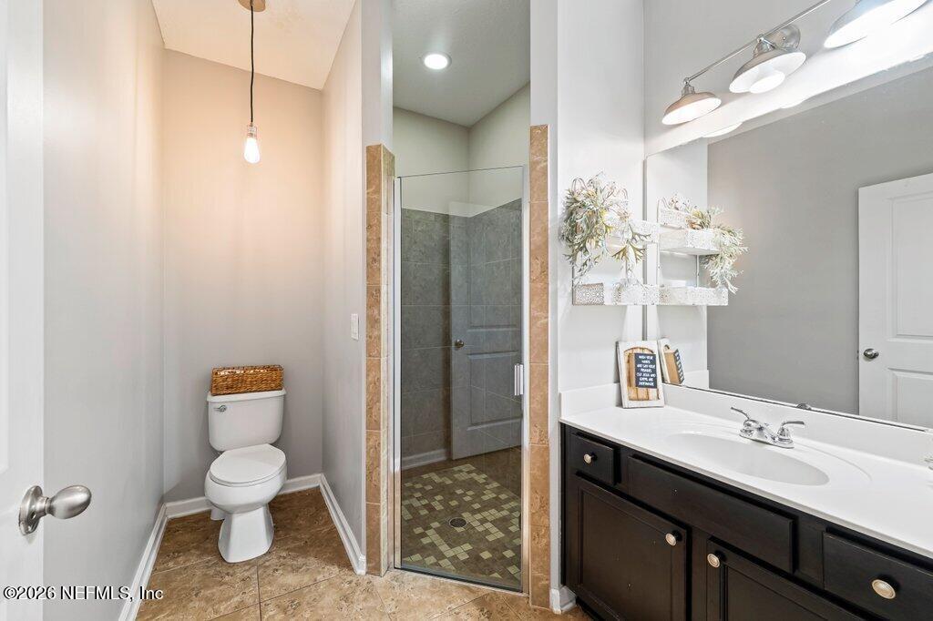 81015 Lockhaven Drive Yulee, FL 32097 - Photo 23 of 55 a bathroom with a toilet a sink and mirror