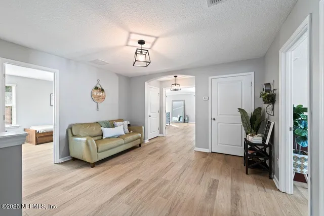 a living room with furniture and a wooden floor