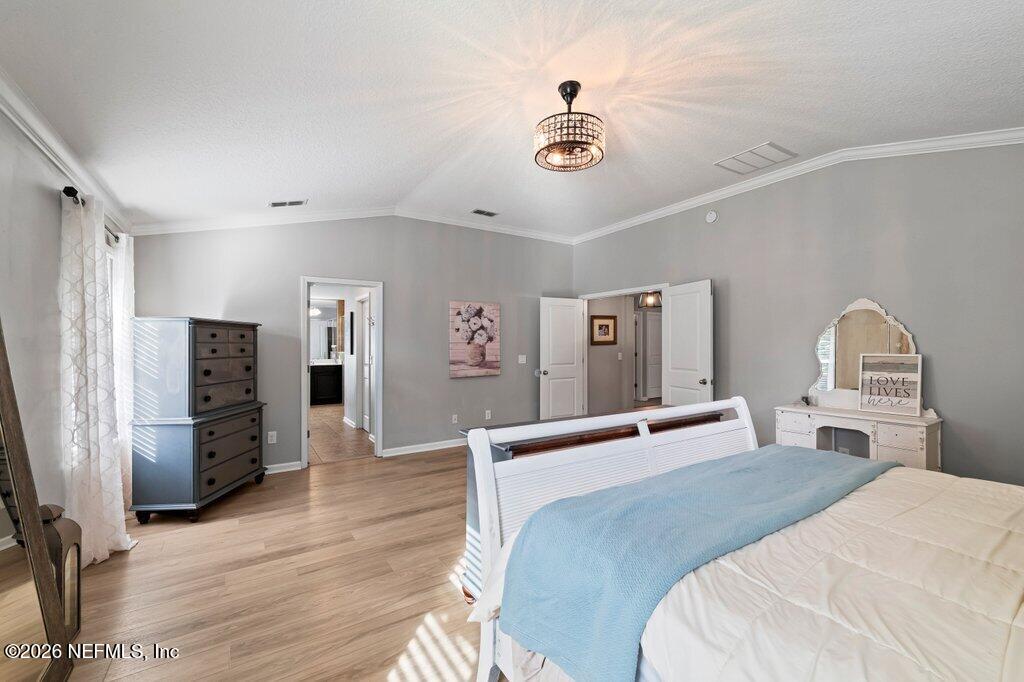 81015 Lockhaven Drive Yulee, FL 32097 - Photo 29 of 55 a bedroom with a bed and wooden floor