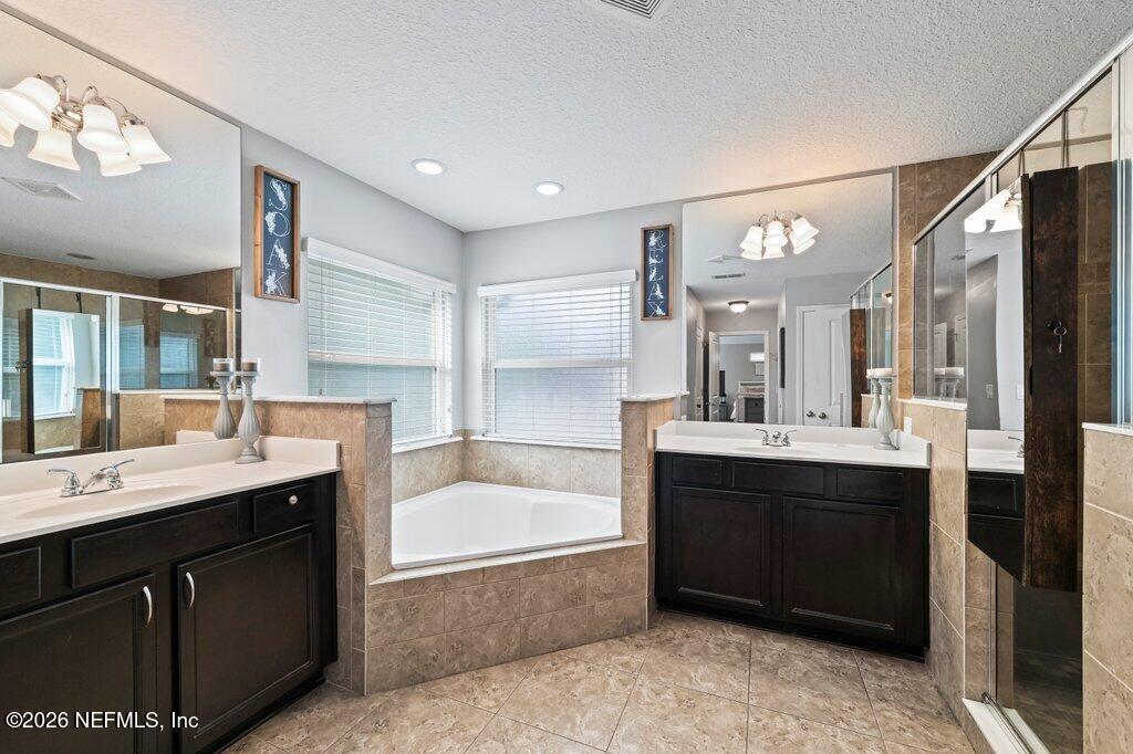 81015 Lockhaven Drive Yulee, FL 32097 - Photo 30 of 55 a spacious bathroom with a sink double vanity granite tub shower and mirror