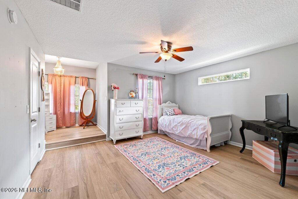 81015 Lockhaven Drive Yulee, FL 32097 - Photo 33 of 55 a bedroom with furniture and a window