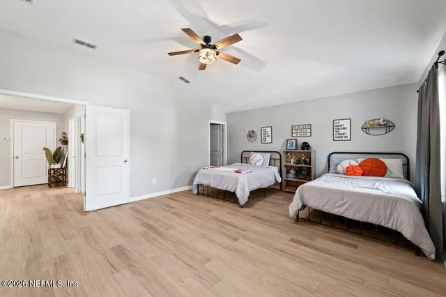 a bed sitting in a bedroom next to a window