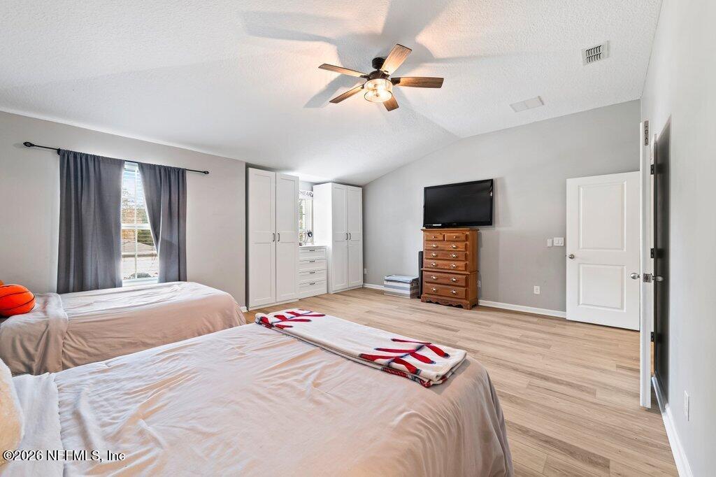 81015 Lockhaven Drive Yulee, FL 32097 - Photo 38 of 55 a bedroom with a bed and a flat screen tv