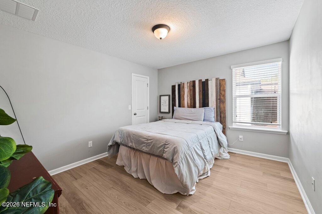 81015 Lockhaven Drive Yulee, FL 32097 - Photo 39 of 55 a bed sitting in a bedroom next to a window