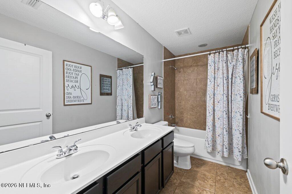 81015 Lockhaven Drive Yulee, FL 32097 - Photo 40 of 55 a bathroom with a double vanity sink mirror and toilet