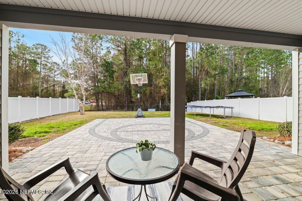 81015 Lockhaven Drive Yulee, FL 32097 - Photo 42 of 55 a swimming pool with outdoor seating and yard