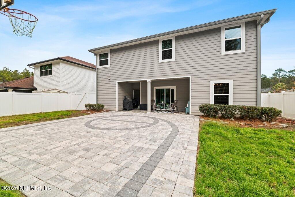81015 Lockhaven Drive Yulee, FL 32097 - Photo 43 of 55 a view of a white house with a yard and large tree