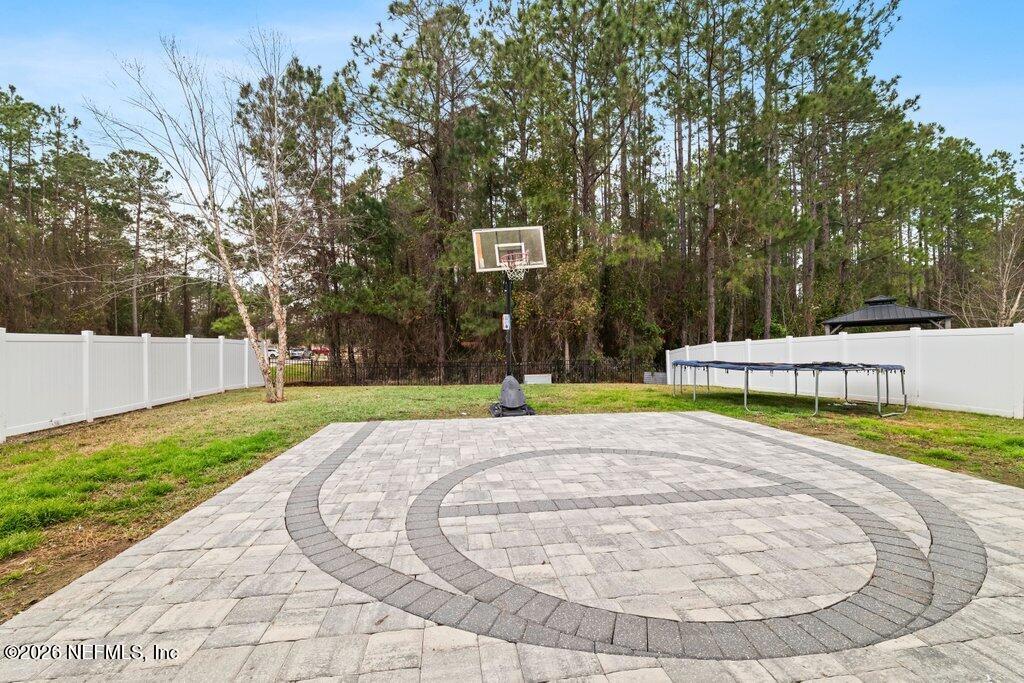 81015 Lockhaven Drive Yulee, FL 32097 - Photo 44 of 55 a view of a swimming pool with a yard