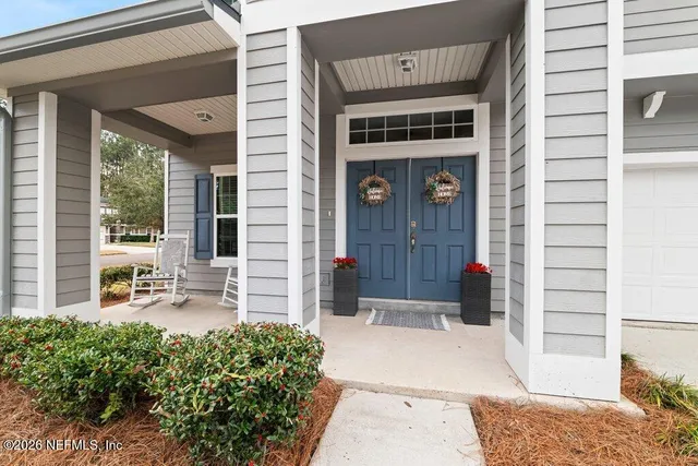 a front view of a house with outdoor seating and plants