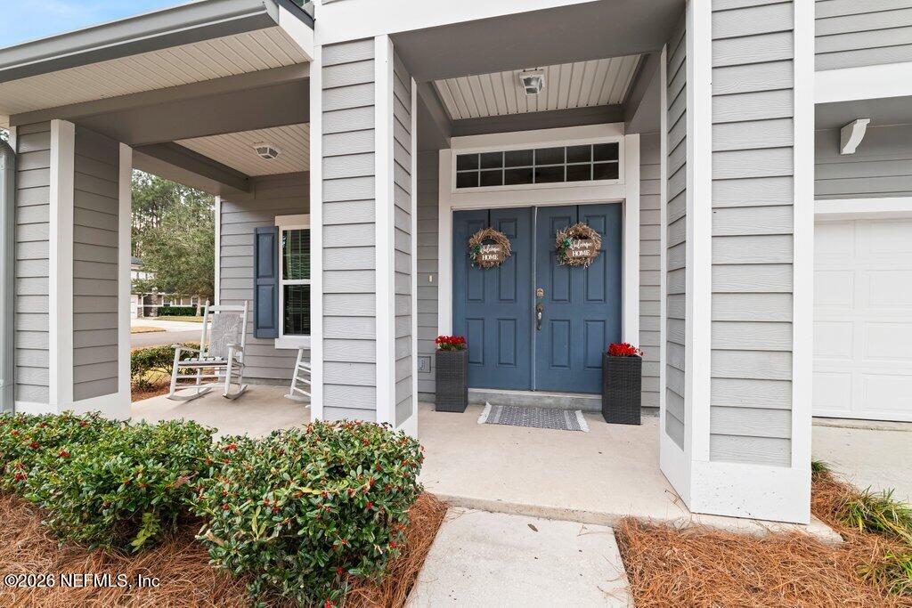 81015 Lockhaven Drive Yulee, FL 32097 - Photo 5 of 55 a front view of a house with outdoor seating and plants