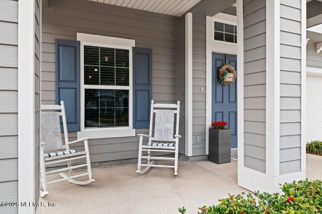 81015 Lockhaven Drive Yulee, FL 32097 - Photo 6 of 55 a house with a bench in front of it