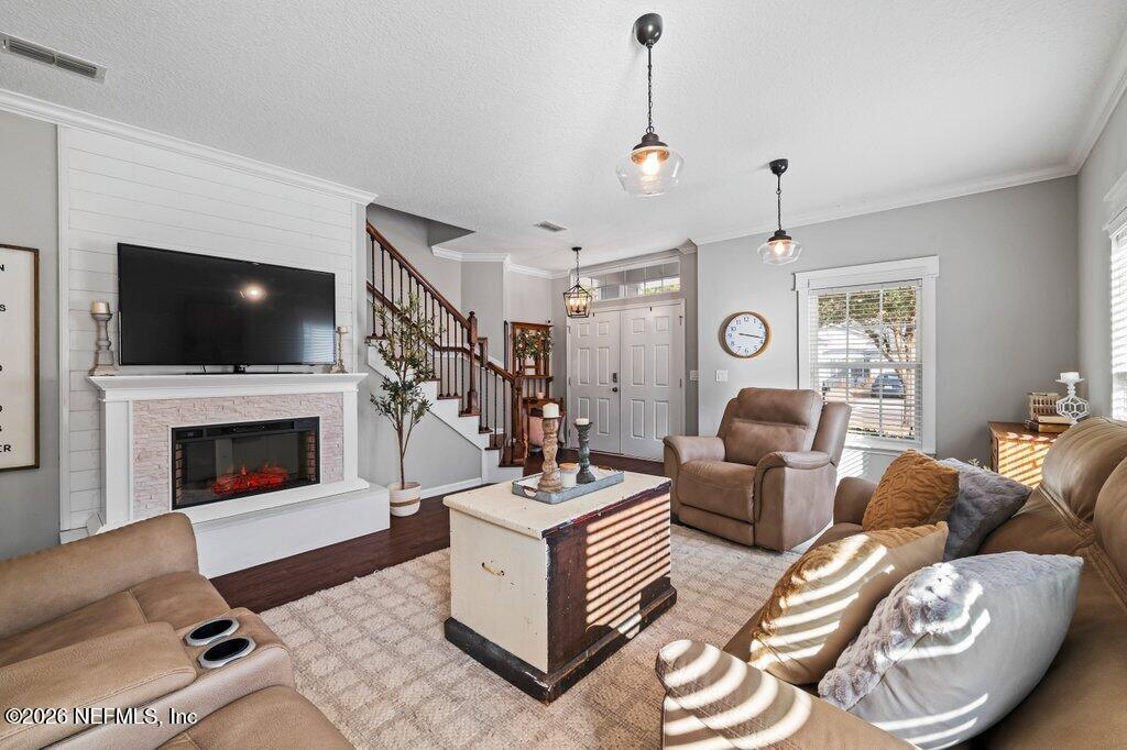 81015 Lockhaven Drive Yulee, FL 32097 - Photo 10 of 55 a living room with furniture a flat screen tv and a fireplace