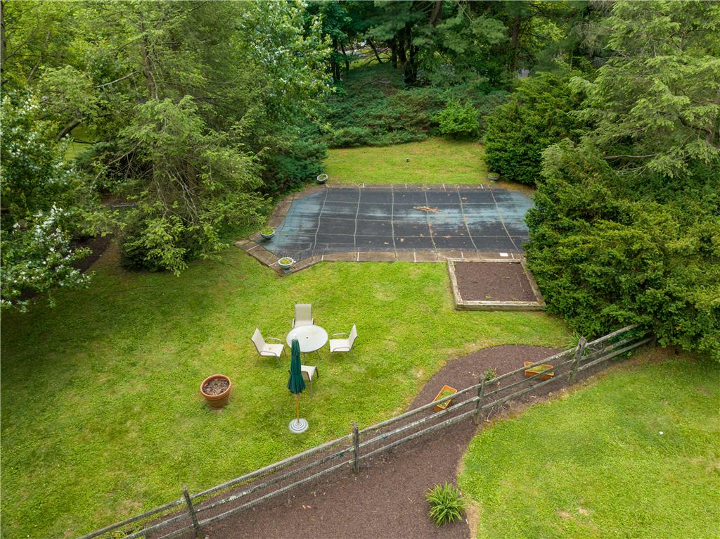 2516 Rachael Lane Orefield, PA 18069 - Photo 39 of 45 A private, green-enclosed outdoor oasis features a covered pool and ample space for relaxation.