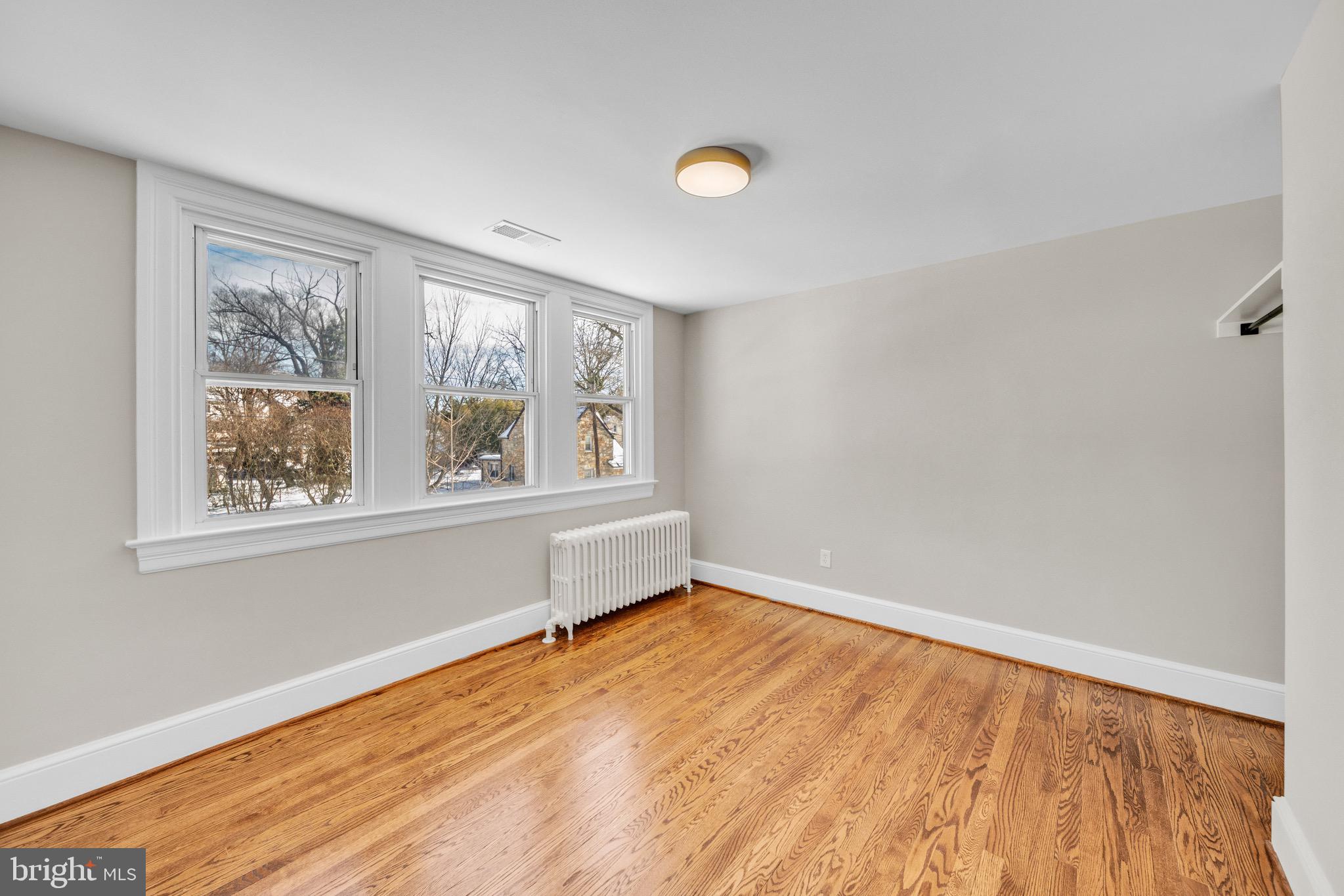 6018 2nd Street Northwest Washington, DC 20011 - Photo 10 of 18 a view of an empty room with wooden floor and a window