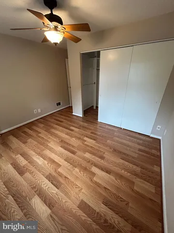 a view of a room with a ceiling fan