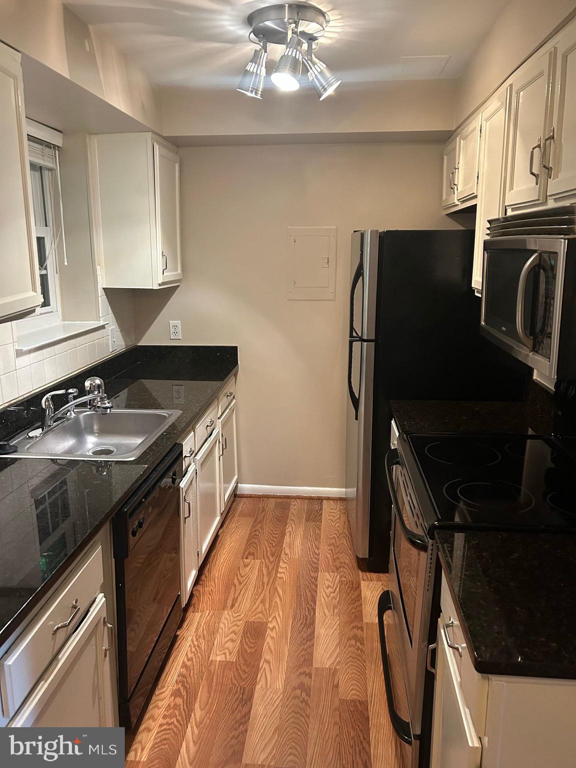 4657 A 28th Road South, Unit A Arlington, VA 22206 - Photo 5 of 12 a kitchen with a sink appliances and cabinets