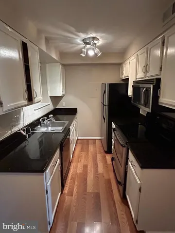 a kitchen with a stove and a refrigerator
