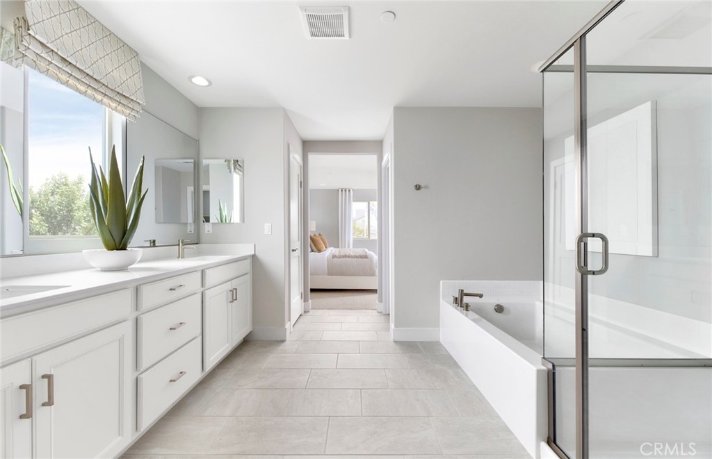 4635 Stratford Place Perris, CA 92571 - Photo 11 of 16 a spacious bathroom with a tub sink and mirror
