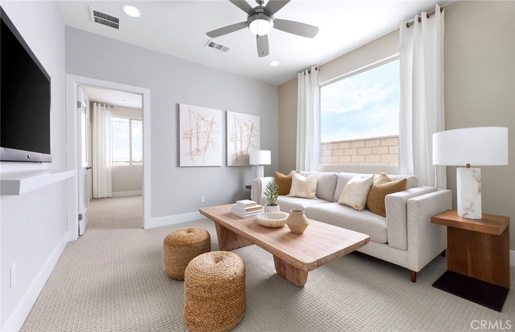 4635 Stratford Place Perris, CA 92571 - Photo 15 of 16 a living room with furniture a flat screen tv and a window