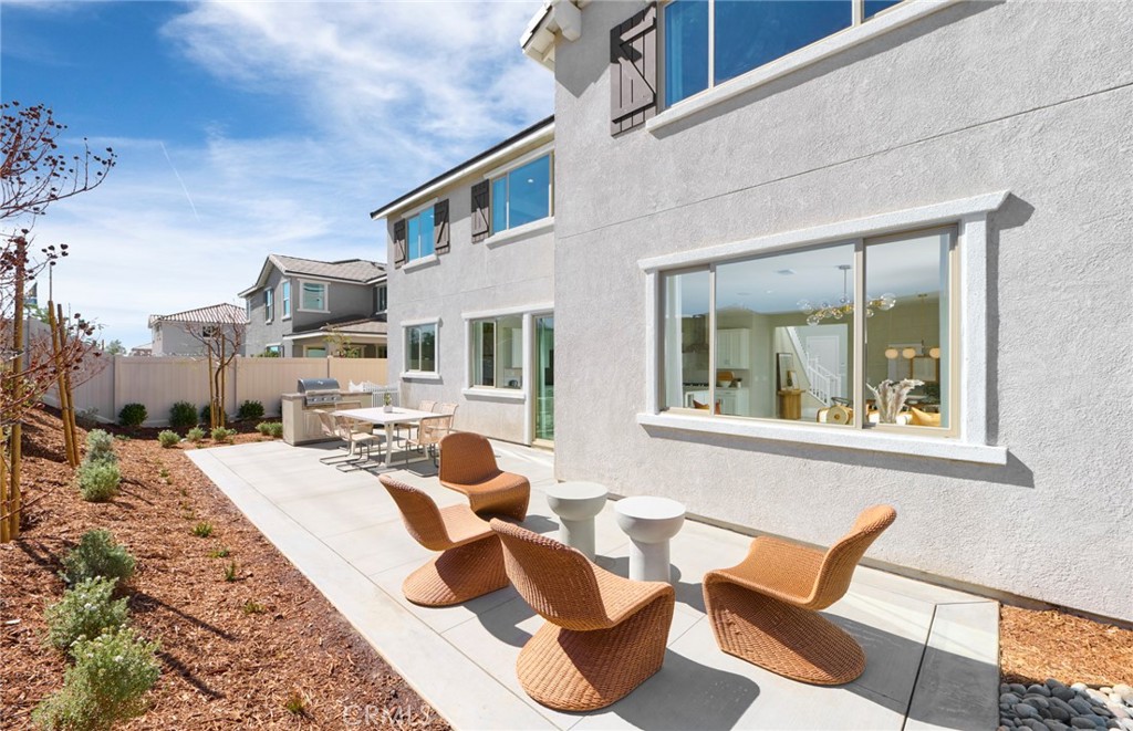 4635 Stratford Place Perris, CA 92571 - Photo 16 of 16 a view of a patio with couches chairs and potted plants