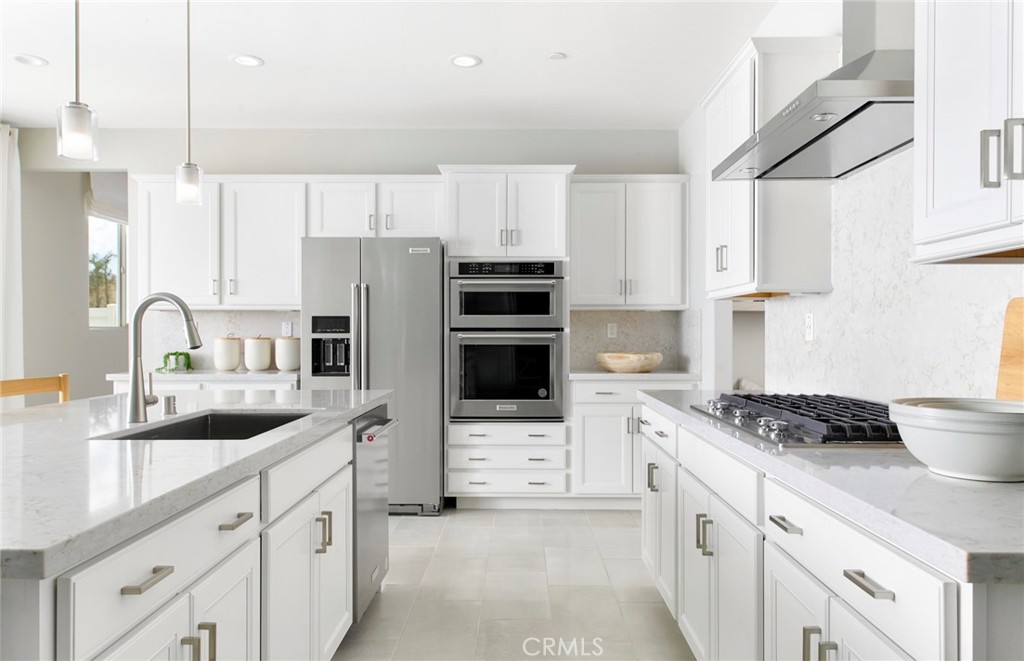 4635 Stratford Place Perris, CA 92571 - Photo 2 of 16 a kitchen with stainless steel appliances a stove sink and refrigerator