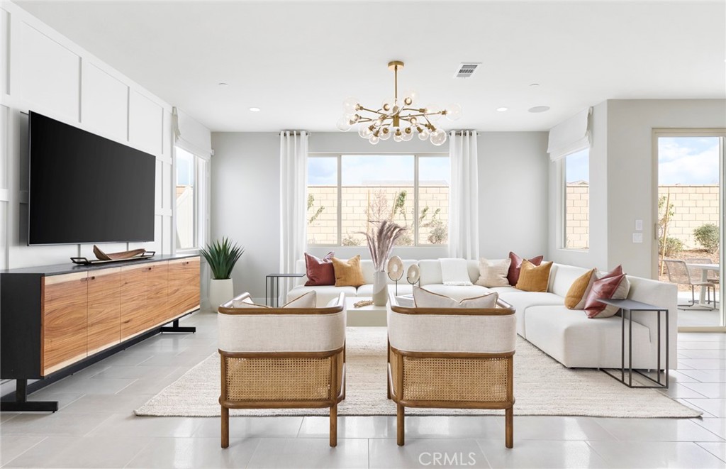 4635 Stratford Place Perris, CA 92571 - Photo 7 of 16 a living room with furniture a flat screen tv and a window