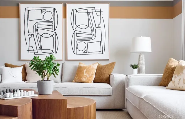 a living room with furniture and a potted plant