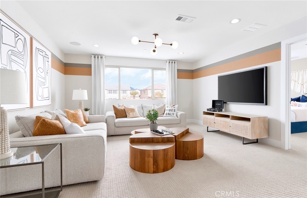 4635 Stratford Place Perris, CA 92571 - Photo 10 of 16 a living room with furniture and a flat screen tv