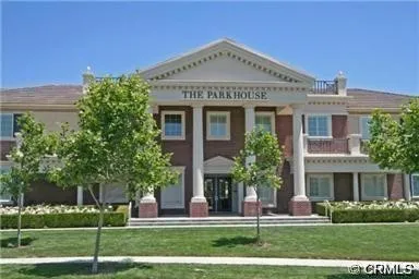 a front view of a building with a garden