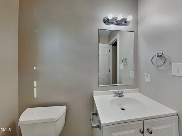 a bathroom with a sink toilet and mirror