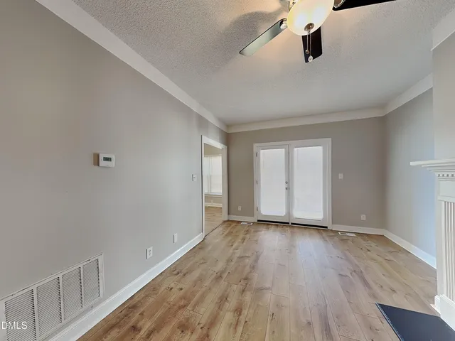 wooden floor in an empty room with a window