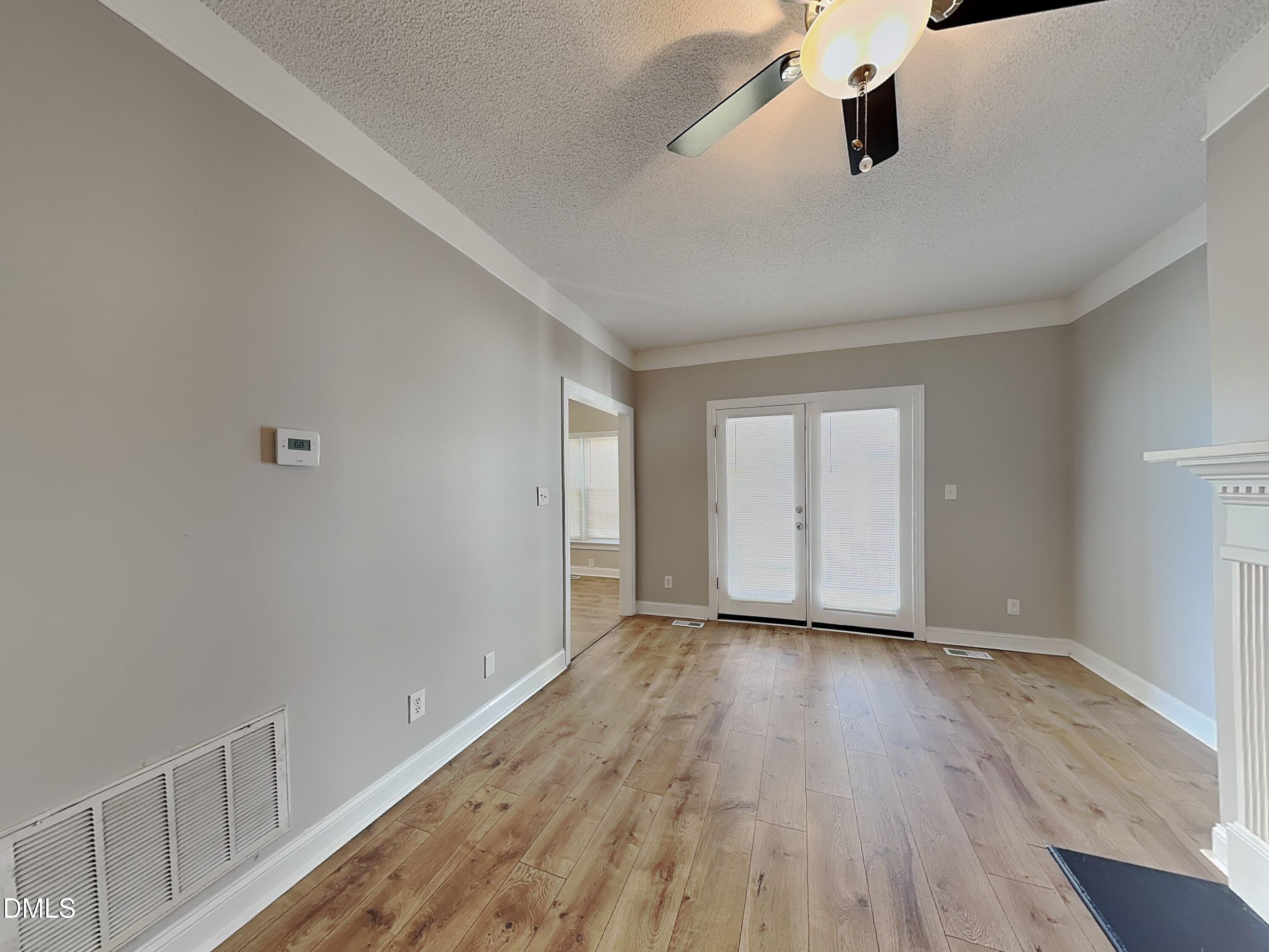 622 Commander Drive Wendell, NC 27591 - Photo 3 of 16 wooden floor in an empty room with a window
