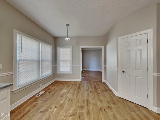 a view of wooden floor and windows in a room