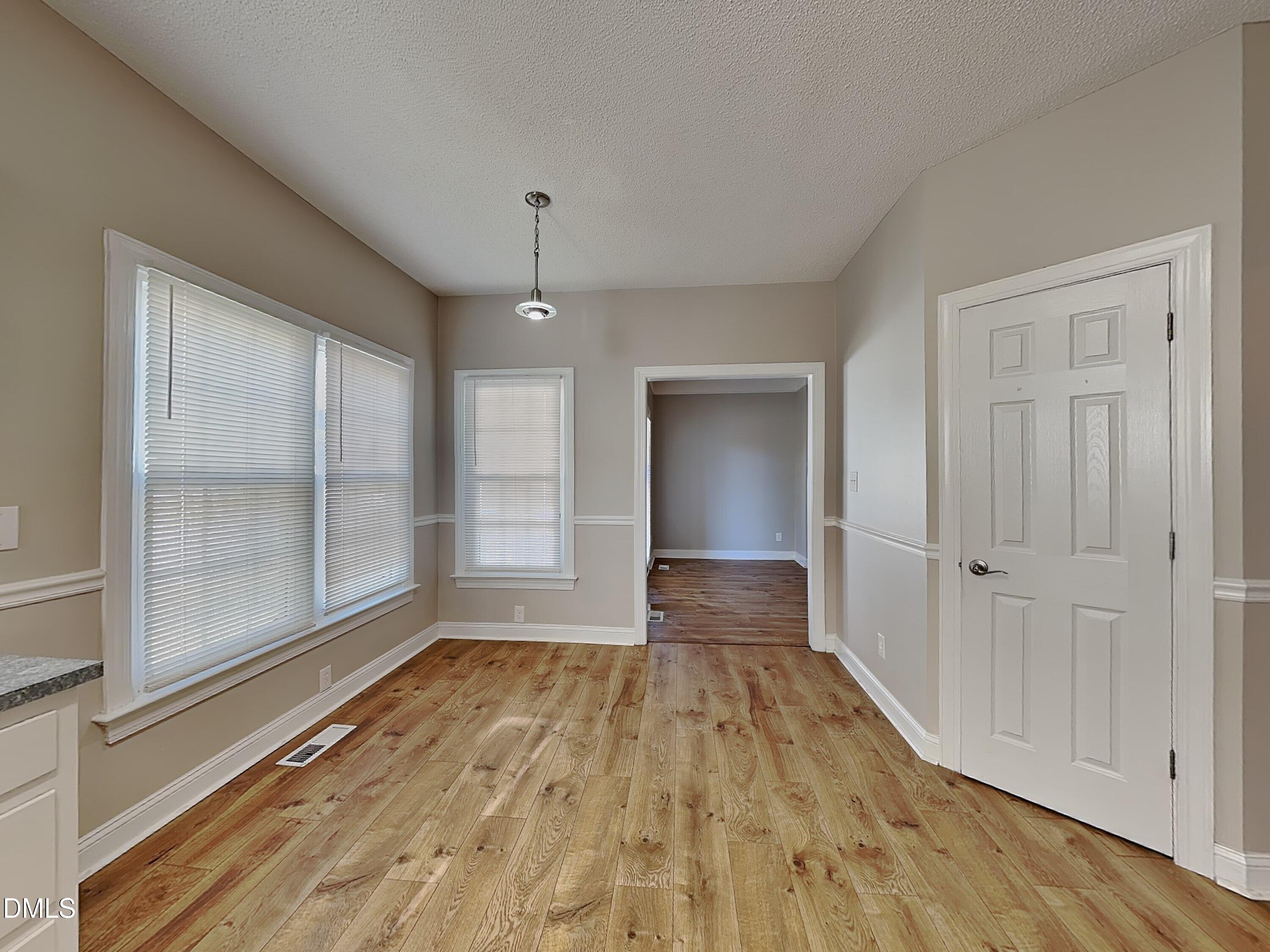 622 Commander Drive Wendell, NC 27591 - Photo 4 of 16 a view of wooden floor and windows in a room
