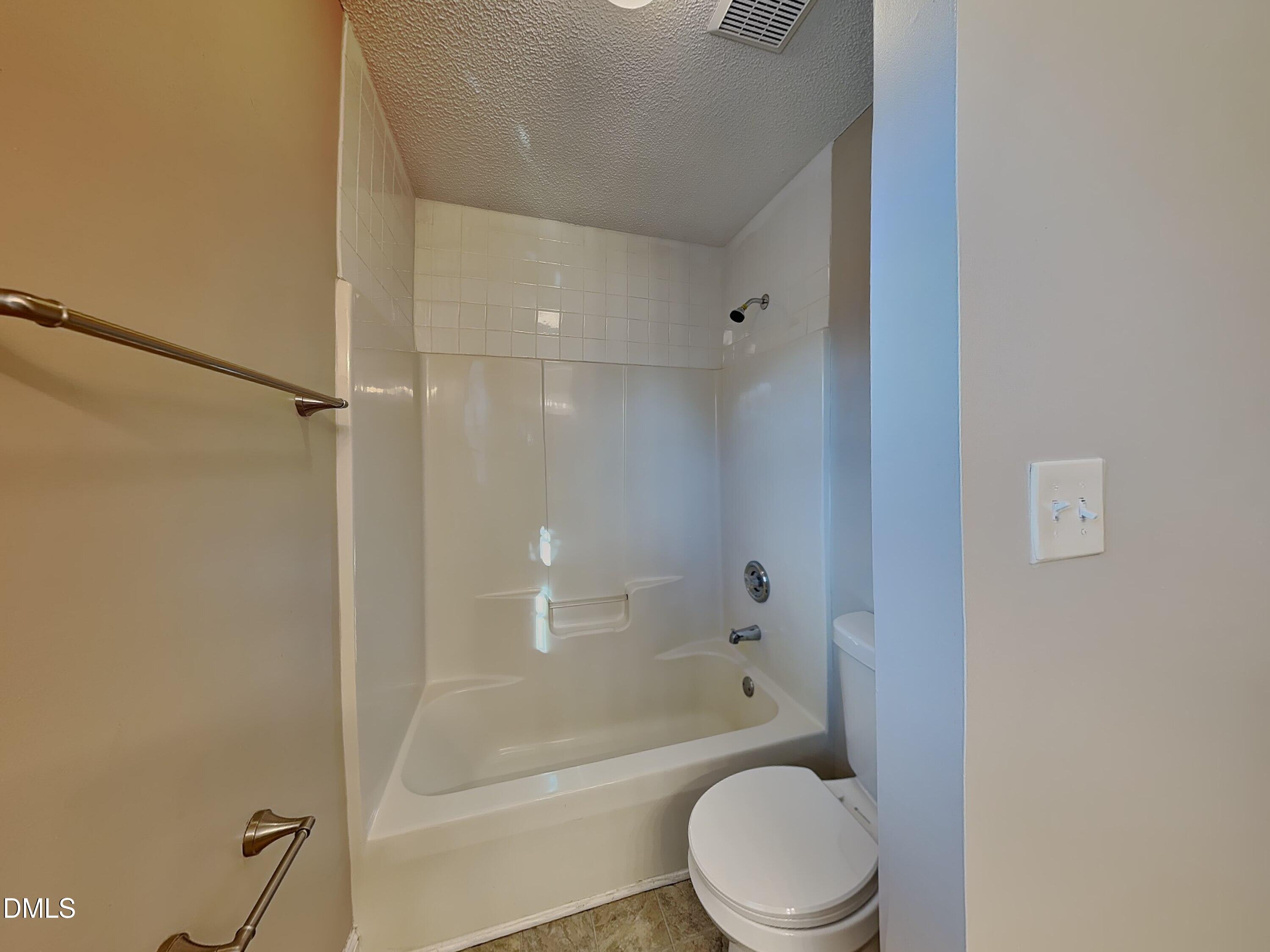 622 Commander Drive Wendell, NC 27591 - Photo 8 of 16 a bathroom with a toilet and a bathtub