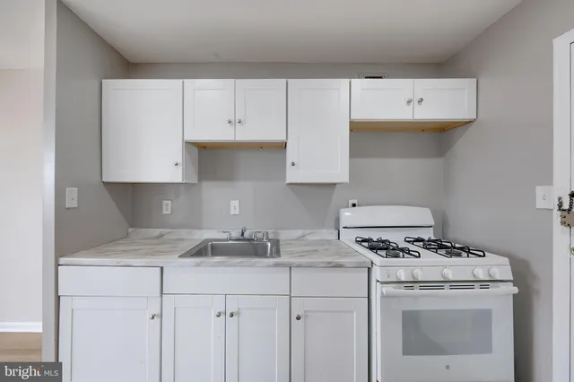 a view of cabinets with refrigerator in kitchen