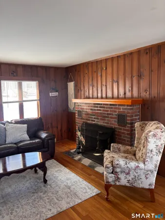 a living room with furniture a rug and a fireplace