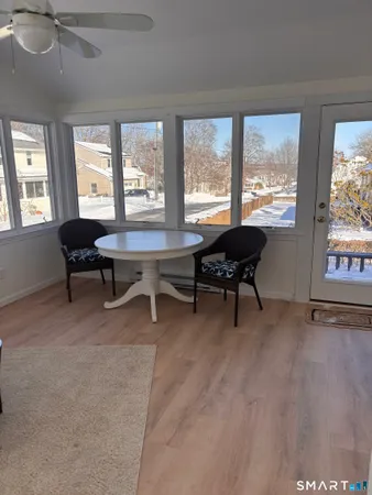 a view of a work space with wooden floor and a window