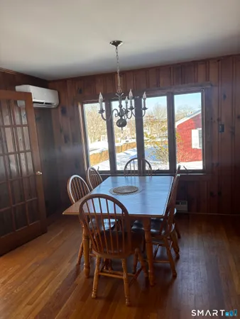 a view of a dining room with furniture window and wooden floor
