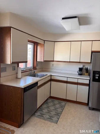 a kitchen with stainless steel appliances granite countertop a sink and a stove