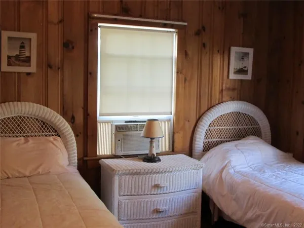 a bedroom with a bed and lamp
