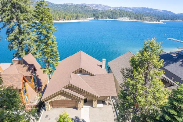 an aerial view of a house with a lake view