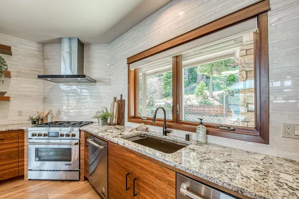 a dining room with furniture a chandelier and wooden floor