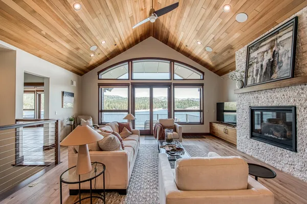 a living room with furniture a fireplace and wooden floor