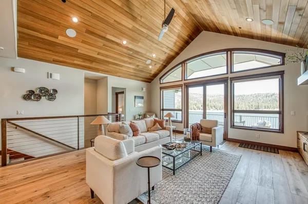 a living room with furniture and floor to ceiling windows