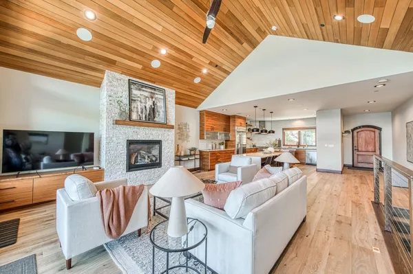 a living room with furniture a fireplace and a flat screen tv