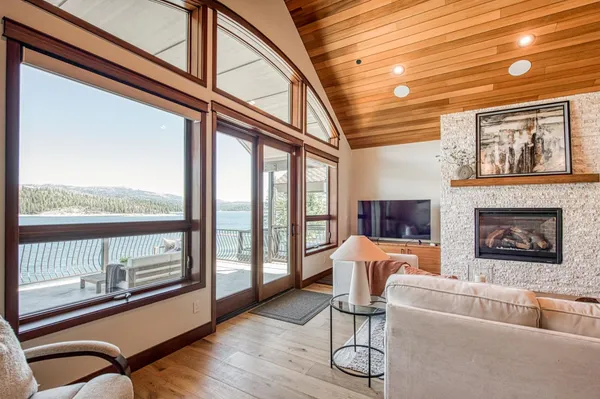 a living room with furniture and a floor to ceiling window