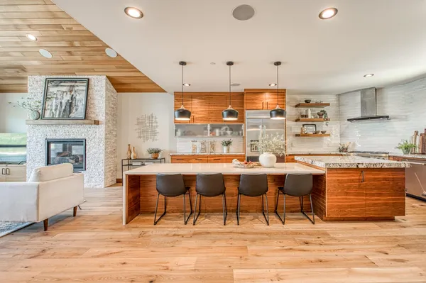 a kitchen with granite countertop sink stove and cabinets
