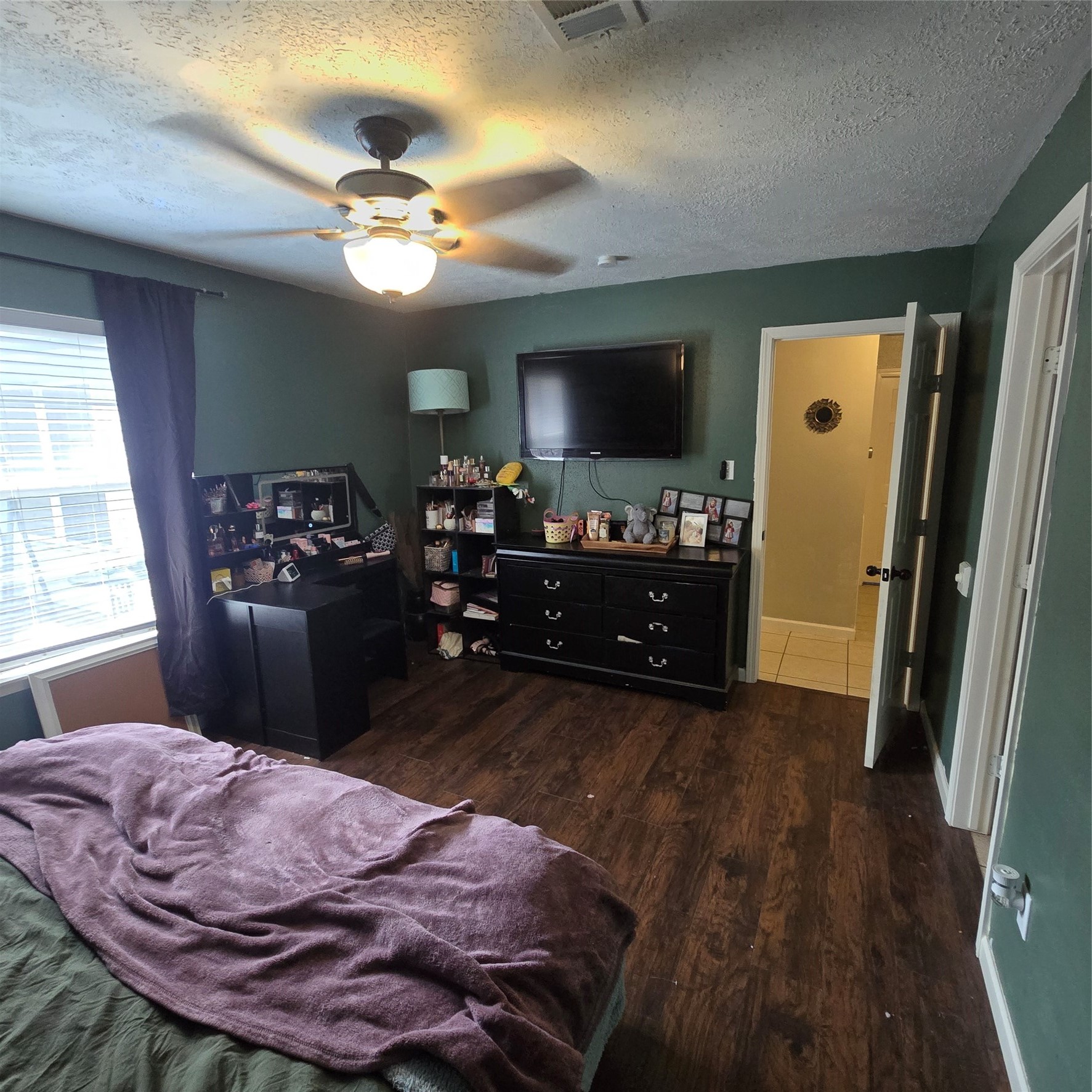 22527 Millgate Drive Spring, TX 77373 - Photo 14 of 30 a bedroom with a bed and wooden floor